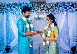 A joyful bride and groom dancing under twinkling string lights in a rustic barn, captured beautifully in our rustic wedding photography packages.